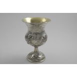 AN EARLY VICTORIAN PRESENTATION GOBLET with repousse-work flowers and wrythen fluting, the thistle-