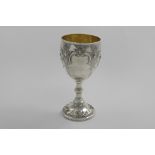 A VICTORIAN GOBLET with embossed decoration and a gilt interior, by Robert Harper, London 1869; 8.3"