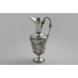 A VICTORIAN WINE JUG of classical form, decorated around the body in relief with a frieze of