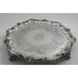 AN EARLY VICTORIAN LARGE SALVER of shaped circular outline with a matted husk & scroll border, and