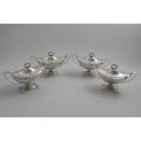 A SET OF FOUR GEORGE III BOAT-SHAPED SAUCE TUREENS AND COVERS with twin angular handles and