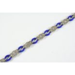 AN ART DECO DIAMOND AND ENAMEL BRACELET formed alternately with diamond set openwork links and