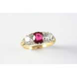 A RUBY AND DIAMOND THREE STONE RING the oval-shaped ruby weighs 1.13 carats and is set with two