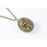 A JAPANESE SHAKUDO LOCKET PENDANT with embossed foliate decoration to one side, the reverse