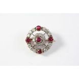 A VICTORIAN RUBY AND DIAMOND TARGET BROOCH mounted with five circular-cut rubies and overall with