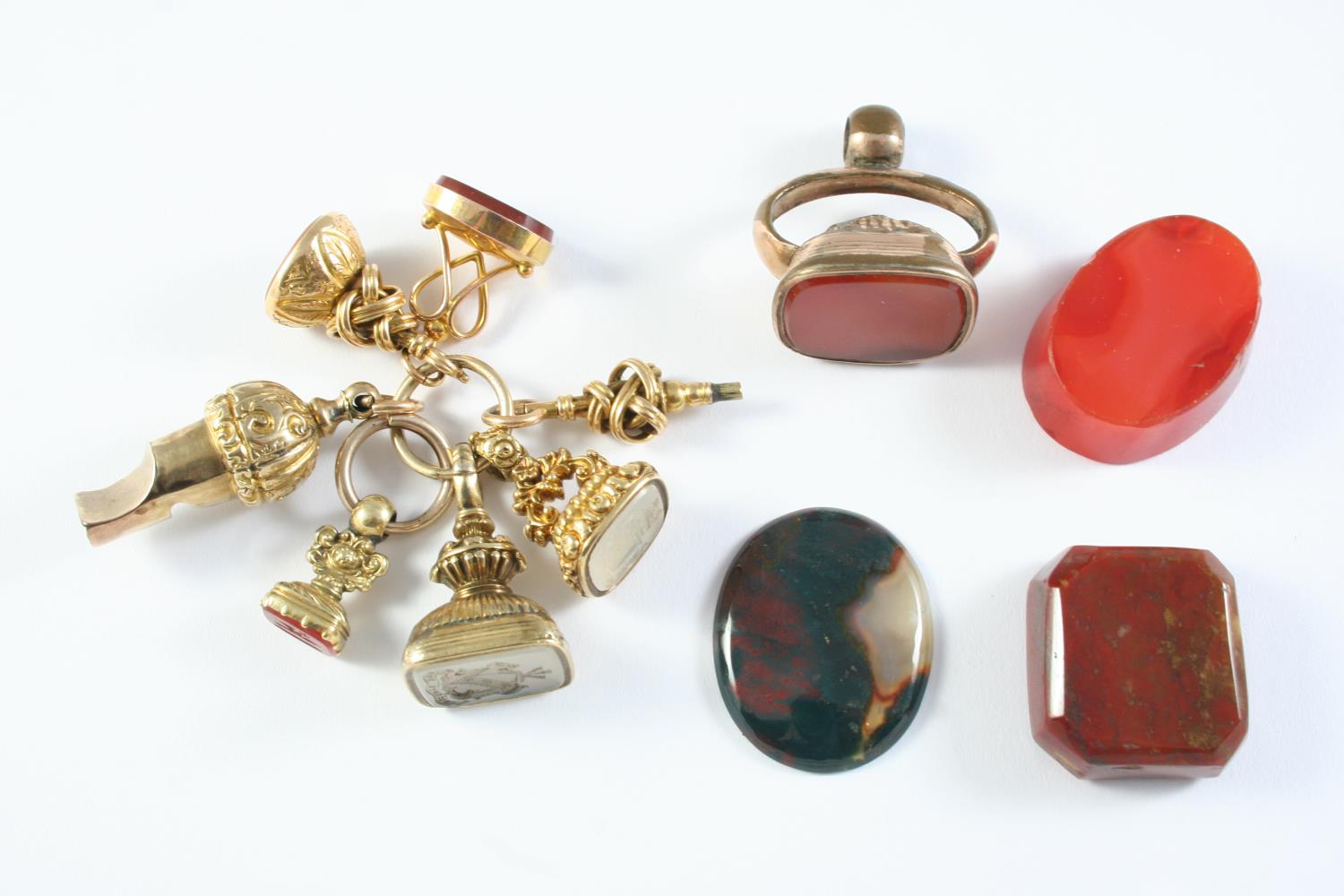 FIVE ASSORTED GOLD FOB SEALS each mounted with a hardstone matrix, a gold watch key and a gold