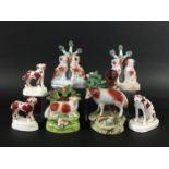 TWO PEARLWARE SHEEP GROUPS early 19th century, one before a spill vase, height 16cm; together with a