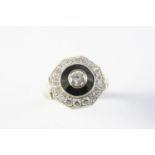 A BLACK ONYX AND DIAMOND CLUSTER RING the central collet set circular-cut diamond is set within a