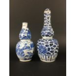 CHINESE BLUE AND WHITE DOUBLE GOURD VASE AND COVER painted with flowers and foliage above lappets,