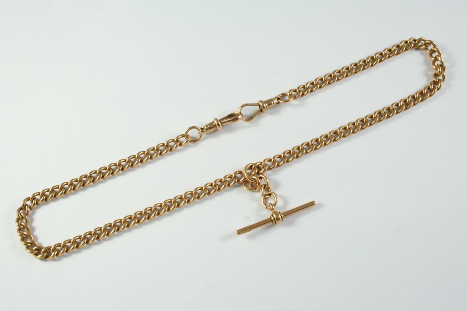 A 15CT GOLD CURB LINK WATCH CHAIN each link stamped for 15ct, suspending a 15ct gold 't' bar, 38.5cm