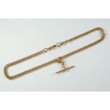 A 15CT GOLD CURB LINK WATCH CHAIN each link stamped for 15ct, suspending a 15ct gold 't' bar, 38.5cm