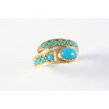A TURQUOISE AND GOLD RING the snake design is set with turquoise cabochons, in gold. Size O