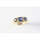 A SAPPHIRE AND DIAMOND RING the three circular-cut sapphires are set with four circular-cut