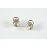 A PAIR OF DIAMOND AND CULTURED PEARL CLIP EARRINGS of scroll design, each earring is set with a