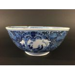 CHINESE BLUE AND WHITE LOTUS BOWL painted with a birds in branches beneath a lotus rim, the exterior