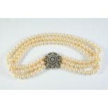 A DIAMOND AND CULTURED PEARL THREE ROW CHOKER the uniform pearls measure approximately 7.2-7.4mm and