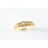 A DIAMOND FIVE STONE RING the five circular old cut diamonds are set in 18ct gold. Size Q 1/2