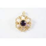 AN EDWARDIAN AMETHYST AND PEARL SET BROOCH PENDANT the 15ct gold openwork foliate mount is centred