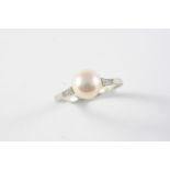 A NATURAL PEARL AND DIAMOND RING the part drilled button-shaped natural pearl is set with four