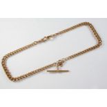 A 9CT GOLD CURB LINK WATCH CHAIN each link stamped 9 375, suspending a 9ct gold 't' bar, 45cm