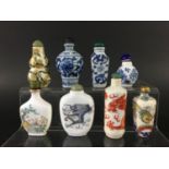 THREE CHINESE BLUE AND WHITE SNUFF BOTTLES including one of faceted form; two painted with