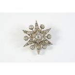 A VICTORIAN DIAMOND STAR BROOCH PENDANT set overall with graduated old cushion-shaped diamonds, in