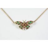 A GOLD AND GEM SET BUTTERFLY PENDANT set overall with circular-cut emeralds, rubies, sapphires and