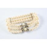 A THREE ROW UNIFORM CULTURED PEARL AND DIAMOND BRACELET the pearls measure approximately 6.2mm and