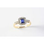 A SAPPHIRE AND DIAMOND CLUSTER RING the square-shaped sapphire is set within a surround of single-