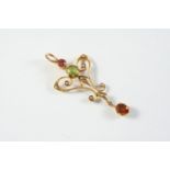 AN EDWARDIAN GOLD AND GEM SET PENDANT the gold openwork mount is set with a green and pink