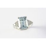 AN AQUAMARINE AND DIAMOND RING the step-cut aquamarine is set with three circular-cut diamonds to