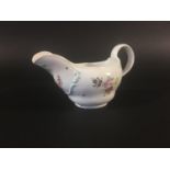 COOKWORTHY BRISTOL PORCELAIN SAUCE BOAT circa 1770, with moulded scrolling and polychrome painted