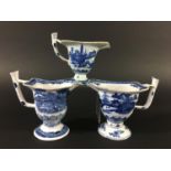 THREE CHINESE BLUE AND WHITE HELMET SHAPED JUGS Qianlong and later, painted with landscapes, width