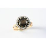A BROWN STAR SAPPHIRE AND DIAMOND RING the circular brown star sapphire is set within a surround