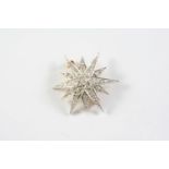 A DIAMOND STAR BROOCH set overall with graduated circular old cut diamonds, in gold, 3.5cm wide