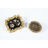 A VICTORIAN BLACK ENAMEL, PEARL AND GOLD MOURNING BROOCH the black enamel centre with applied gold