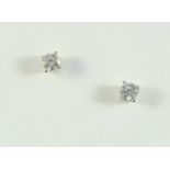 A PAIR OF DIAMOND STUD EARRRINGS the two brilliant-cut diamonds weigh approximately 0.78 carats in