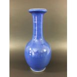CHINESE MONOCHROME BLUE VASE of baluster form, with a slightly speckled glaze shading to white at