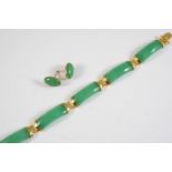 A JADE AND GOLD PANEL BRACELET formed with five rectangular panels of jade with gold terminals, 19cm