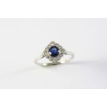 AN ART DECO SAPPHIRE AND DIAMOND RING the circular-cut sapphire is set within a surround of single-