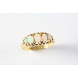 AN OPAL FIVE STONE RING the five graduated oval solid white opals are set in 18ct gold. Size L 1/2
