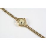 A LADY'S 9CT GOLD WRISTWATCH the circular dial with Arabic numerals, numbered to the reverse