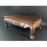 CHINESE HARDWOOD OPIUM TABLE with a scrolling apron and claw feet on short legs, height 27.5cm,