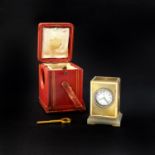 A GOLD, ENAMEL AND AGATE MINIATURE CARRIAGE CLOCK BY CARTIER the rectangular engine turned gold case