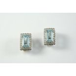 A PAIR OF AQUAMARINE AND DIAMOND CLUSTER CLIP EARRINGS each set with a step-cut aquamarine within