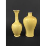 TWO CHINESE MONOCHROME YELLOW VASES of bottle and meiping form, bottle vase with six character