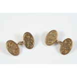 A PAIR OF 9CT GOLD CUFFLINKS of oval shape, each link with engraved foliate decoration, hallmarked