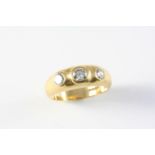 A DIAMOND AND GOLD GYPSY RING the 18ct gold band is set with three brilliant-cut diamonds. Size Q