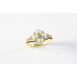 A VICTORIAN DIAMOND, PEARL AND ENAMEL CLUSTER RING the quatrefoil design is mounted with half pearls