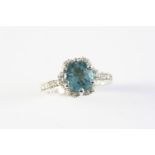 A TOURMALINE AND DIAMOND CLUSTER RING the indicolite tourmaline is set within a surround of